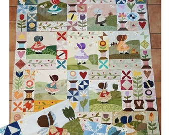 Könnte beinhalten: Ein Quiltmuster mit Patchwork-Design zum Thema Mädchen mit Sonnenhut. Der Quilt besteht aus verschiedenen bunten Stoffen und enthält verschiedene Designs wie Blumen, Vögel und Herzen. Der Quilt ist 65 Zoll mal 77 Zoll groß.