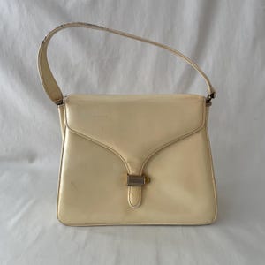 Bolso de mano vintage de piel color crema de los años 50 que necesita limpieza