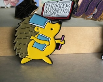 Hedgehog Running with Book on head with Pencil Enamel pin.