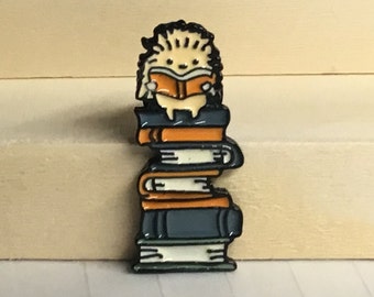 Hedgehog sitting on a pile of books reading