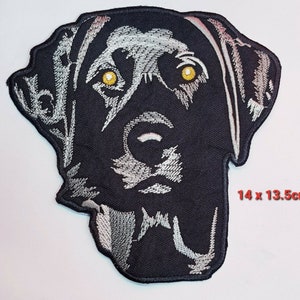 May include: Black embroidered iron-on patch of a Labrador Retriever dog's head with yellow eyes. The patch measures 14 x 13.5 cm.