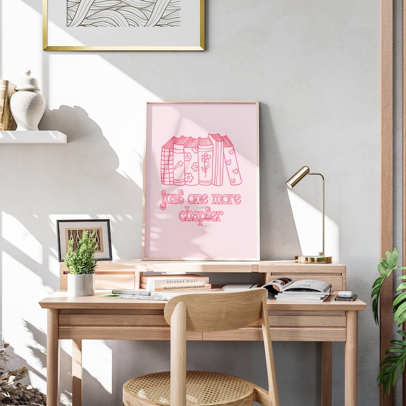 May include: Pink and white print with a stack of books and the text "Just one more chapter".