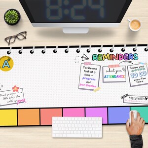 May include: A black and white desk mat with a colorful design. The mat has a grid pattern and includes the text "REMINDERS" with three colorful reminder boxes. The boxes include the text "Tackle one task at a time - progress not perfection", "Submit your attendance", and "Review your to do every few hours". The mat also includes a small sticker with the letter "A" and the text "Track progress - little every day adds up".
