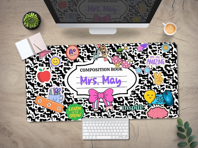 May include: Black and white leopard print desk mat with colourful school-themed stickers and the text "COMPOSITION BOOK Mrs. May".