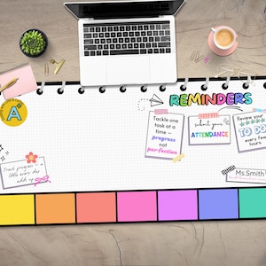 May include: A white desk mat with a black border and a colorful design. The mat has a grid pattern and includes the text "REMINDERS" in a rainbow font. There are three colorful sticky notes with the text "Tackle one task at a time - progress not perfection", "Submit your attendance", and "Review your to do every few hours".