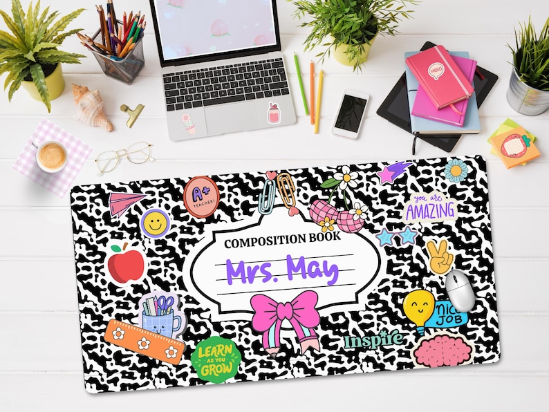May include: Black and white leopard print composition book with colourful stickers and the text "Composition Book Mrs. May" in a purple font.