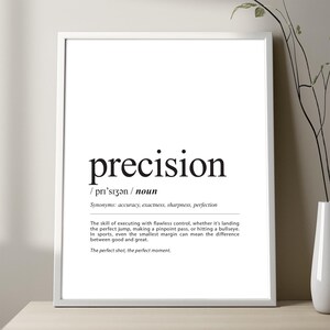 May include: Black and white printable wall art with the definition of the word "precision". The definition reads: "The skill of executing with flawless control, whether it's landing the perfect jump, making a pinpoint pass, or hitting a bullseye. In sports, even the smallest margin can mean the difference between good and great. The perfect shot, the perfect moment."