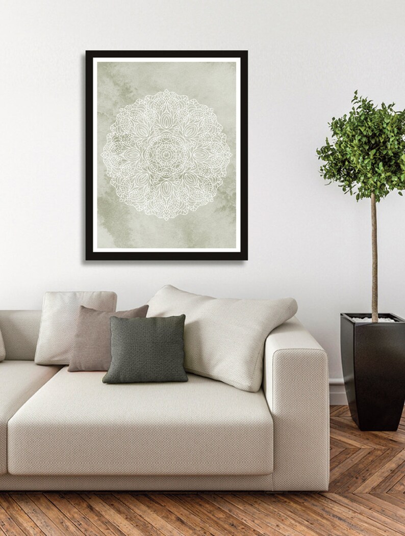 May include: A framed print of a white mandala design on a light green watercolor background.