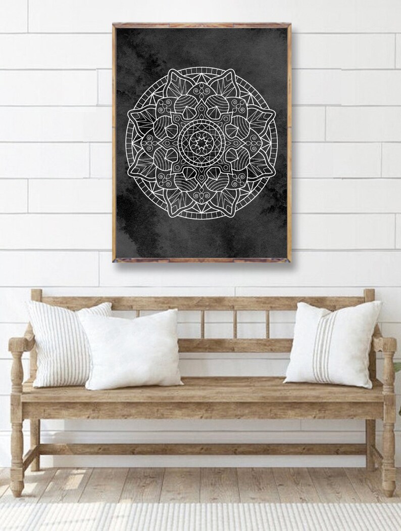 May include: A black and white mandala design on a dark gray background. The mandala is a circular pattern with intricate details and is framed in a wooden frame.