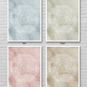 May include: Four printable wall art prints featuring white mandala designs on different colored backgrounds. The colors are blue, green, pink, and sand.
