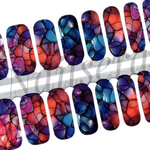 May include: Set of 12 nail wraps with a colourful abstract design featuring blue, red, and purple swirls. The swirls resemble stained glass or a marble effect.