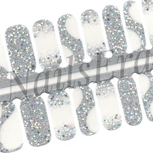 Puede incluir: Un conjunto de 10 envolturas para uñas con base blanca y purpurina plateada. La purpurina tiene un patrón ondulado. Las envolturas para uñas están diseñadas para usarse en las uñas.