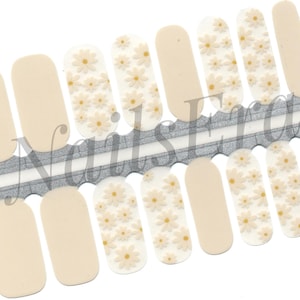 May include: Nail art strips with a combination of plain beige and white nail wraps. The white wraps are decorated with tiny, raised daisy flower patterns in a pale yellow hue. The strips are presented on a silver and white backing.