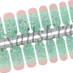 May include: Set of 10 green and pink glitter nail wraps with a gradient effect. The nail wraps are arranged in a row on a white background. The text "NailsEra" is printed on the background.