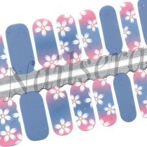 May include: Nail polish wraps with a pink and blue ombre design featuring white cherry blossoms. The wraps are designed to fit all ten fingernails.