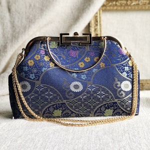 Vintage cheongsam style kiss lock hand bag with navy blue nishijin Japanese traditional patterns style with gold frame, clasp and chain. image 1