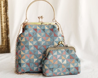 cheongsam style Turquoise triangle kiss lock handbag with triangular patterns, gold metal clasp and soft cream interior .
