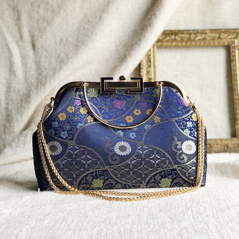 Vintage cheongsam style kiss lock hand bag with navy blue nishijin Japanese traditional patterns style with gold frame, clasp and chain. image 1