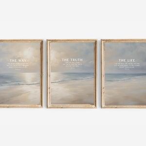 May include: Three framed art prints depicting a beach scene in muted tones of beige, blue, and white. Each print displays the words "THE WAY", "THE TRUTH", and "THE LIFE", along with related verses, all within a wooden frame.