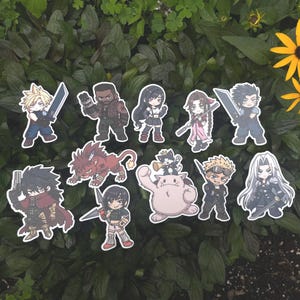 May include: A collection of ten die-cut vinyl stickers featuring chibi-style characters from Final Fantasy VII, including Cloud Strife, Barret Wallace, Tifa Lockhart, Aerith Gainsborough, Zack Fair, Vincent Valentine, Yuffie Kisaragi, Red XIII, Cait Sith, and Sephiroth.