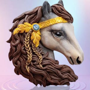 May include: A decorative horse head sculpture with a white face, brown mane, and a gold headband. The sculpture features gold leaf accents and a blue gemstone. The horse head is set against a soft, gradient background.