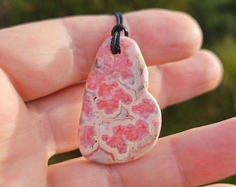Top quality Argentinian rhodochrosite pendant. High quality rhodochrosite necklace