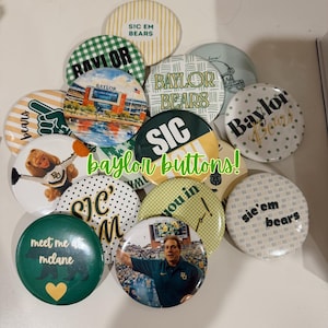 May include: A collection of round pin-back buttons featuring various Baylor University designs, including text like 'Sic Em Bears', 'Baylor Bears', and 'Meet me at McLane', alongside images of a stadium, a cheerleader, and a coach in a green shirt.