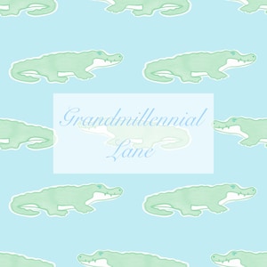 May include: A light blue background with a repeating pattern of green alligators. The text "Grandmillennial Lane" is centered in the middle of the image.