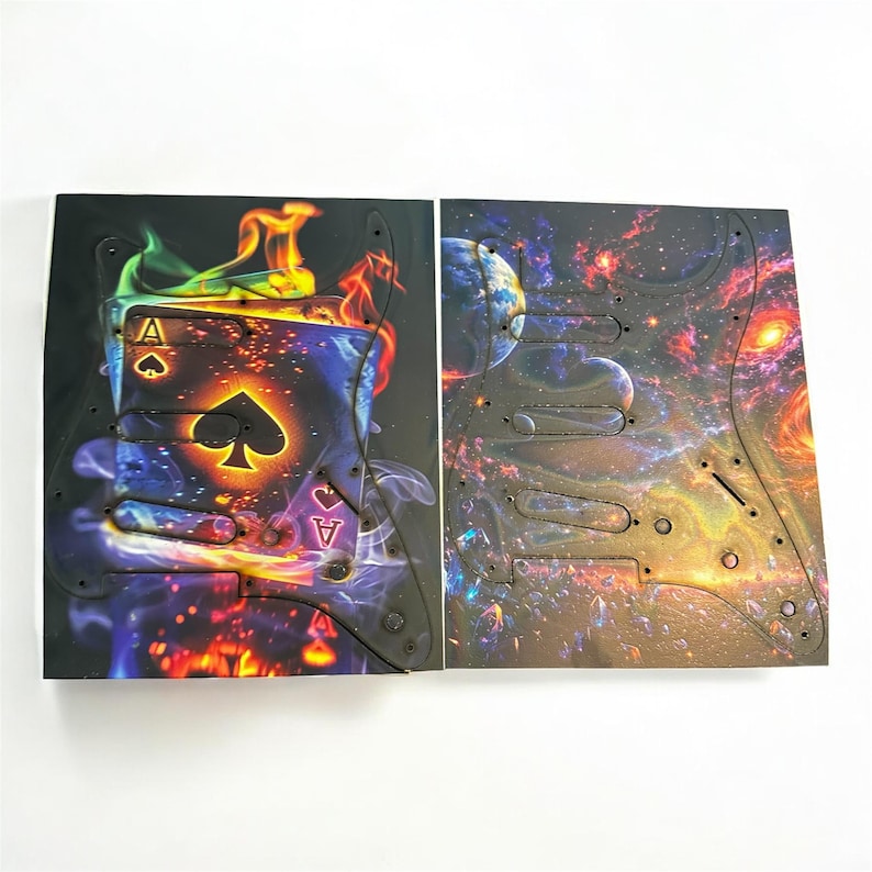 May include: Two guitar pickguards with unique designs. One features a flaming Ace of Spades card, the other a vibrant galaxy scene. Both are black with pre-drilled holes for easy installation on an electric guitar.