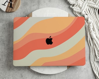 May include: A laptop computer with a colourful abstract design on the lid. The design features wavy lines in shades of orange, yellow, and beige. The Apple logo is visible in the centre of the lid.