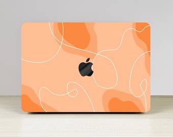 May include: A peach-coloured laptop skin with a white abstract design and a black Apple logo.