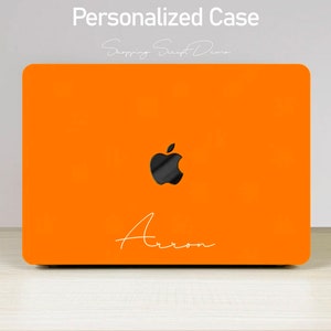 May include: Orange laptop case with a black Apple logo and the name "Arron" written in white script.