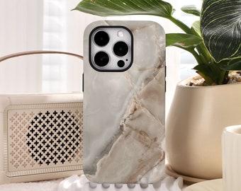 May include: A white and brown marble phone case with a black camera lens cutout. The case is designed for an iPhone.