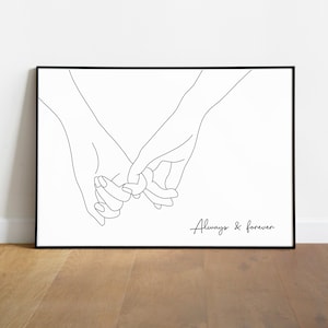 May include: A black framed art print with a minimalist line drawing of two hands holding pinky fingers. The words "Always & forever" are written in a script font below the hands. The artwork is on a white background.