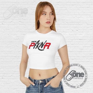 May include: White cropped t-shirt with short sleeves and a black and red graphic that says "To Say I'm In PKR".