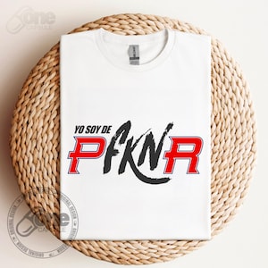 May include: White t-shirt with a black and red graphic that says "Yo soy de PFKN" with a red "R" and a black circle around the "N".