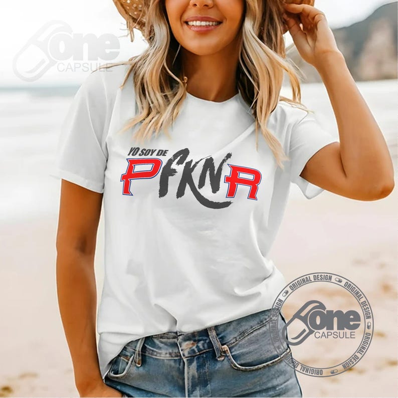 May include: White t-shirt with a black and red graphic that says "Yo soy de PFKN" on it.