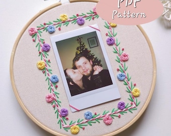 May include: An embroidery hoop with a cream fabric background, featuring a photograph at the centre. The photo is framed by a floral embroidery design in pink, yellow, blue, and purple. The text "PDF Pattern" is in a pink oval.