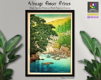 May include: Vintage Japanese woodblock print poster of a river scene with green trees and a blue sky. The print is framed in black and has a white border.