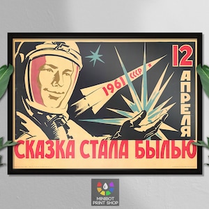 May include: A vintage Soviet propaganda poster featuring a cosmonaut in a spacesuit with a red star on his helmet. The poster is set against a black background with a stylized rocket and a burst of light. The text on the poster reads "12 апреля" (April 12th) and "Сказка стала былью" (The fairy tale became reality).