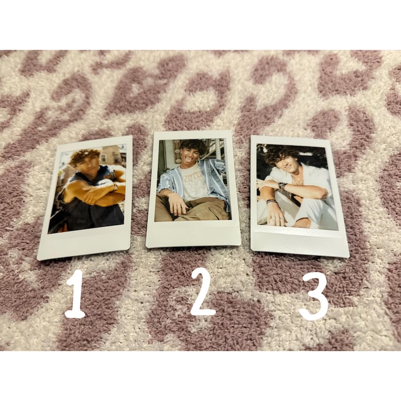 May include: Three white polaroid-style photos with images of a person. The photos are numbered 1, 2, and 3. The background is a patterned rug in shades of purple and white.