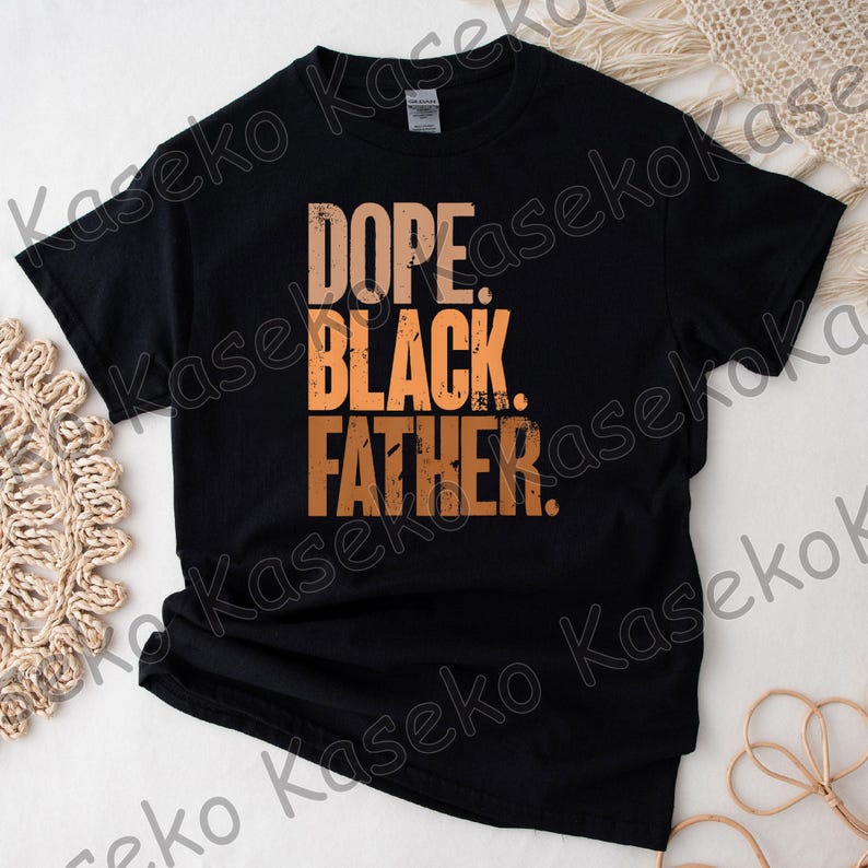 May include: Black t-shirt with the words "DOPE. BLACK. FATHER." in a gradient orange font. The shirt is made of a soft material and is likely a casual wear item. The text is centered on the front of the shirt.
