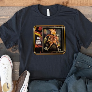 May include: A black t-shirt featuring a graphic print of a vintage album cover with a skeletal figure and the text "Cool Astral Disaster".