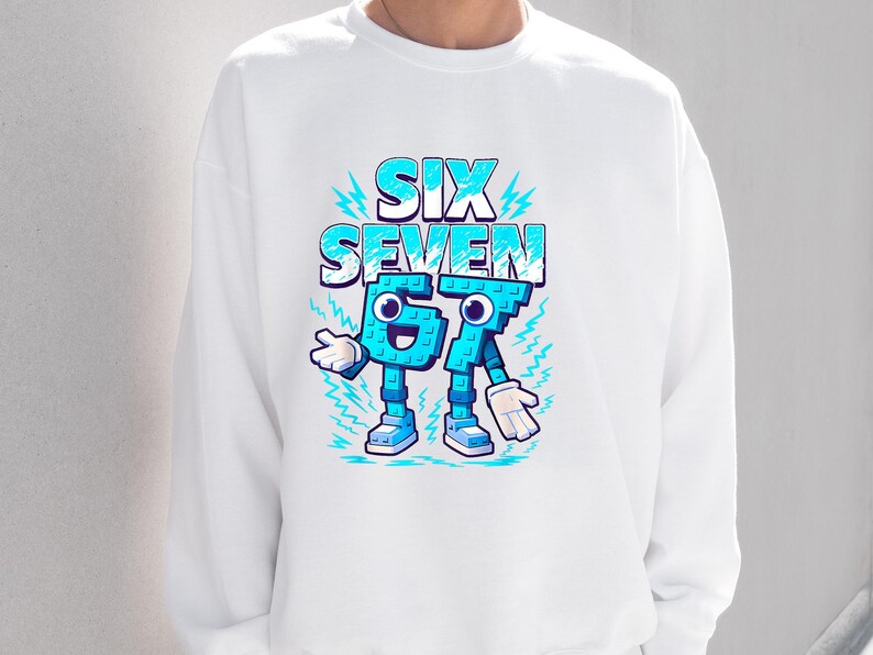 May include: White sweatshirt with a cartoon design. The words "SIX SEVEN" are in blue and white, with the numbers 6 and 7 personified with arms, legs, and shoes. Lightning bolt accents surround the text.