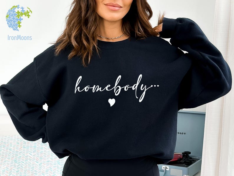 May include: Black sweatshirt with the text "homebody..." in white cursive lettering and a small white heart.