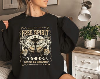 May include: Black sweatshirt with a vintage-style graphic featuring a butterfly, stars, and the text "Free Spirit Dream On Dreamer".