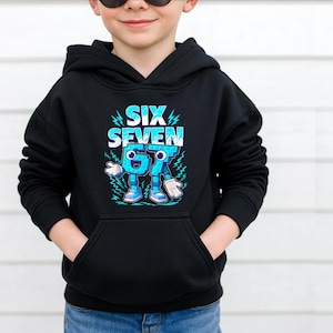 May include: Black hooded sweatshirt with a front pocket. The sweatshirt features the text "SIX SEVEN" in white and blue, with a cartoon number 67 character. The design includes lightning bolts and a cartoon character.