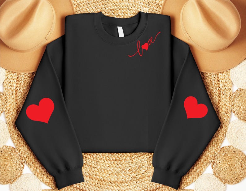 May include: Black sweatshirt with red hearts on the sleeves and the word "Love" with a heart on the front.