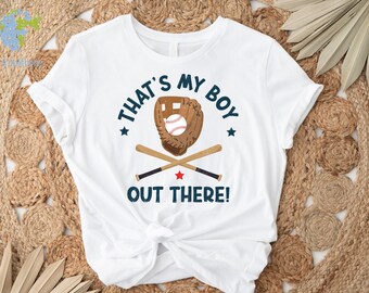 May include: White t-shirt with a blue graphic that says "That's My Boy" with a baseball glove and bats. The text "Out There!" is below the graphic.