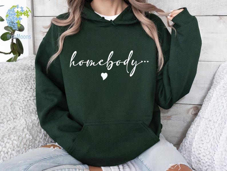 May include: A dark green hoodie with a white graphic that says "homebody..." with a small heart.